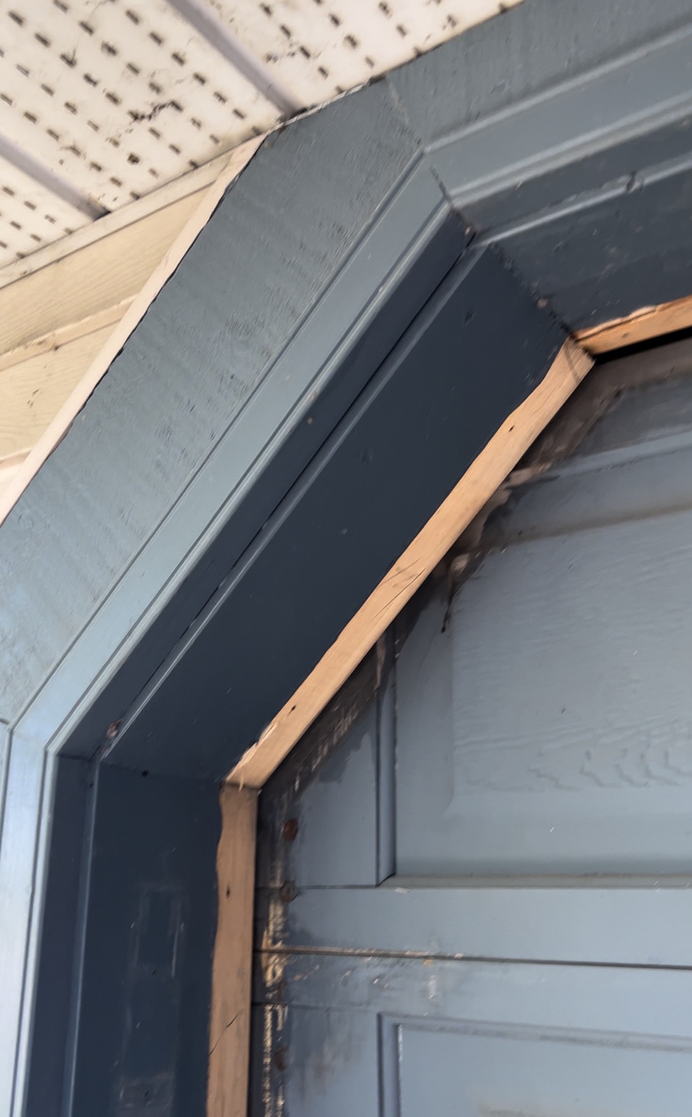 Garage Corner — before: worn painted wood trim (Calgary)