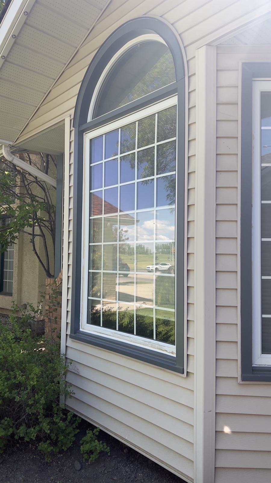 Arch Window — after: capped in custom-bent aluminum, no more repainting (Calgary)