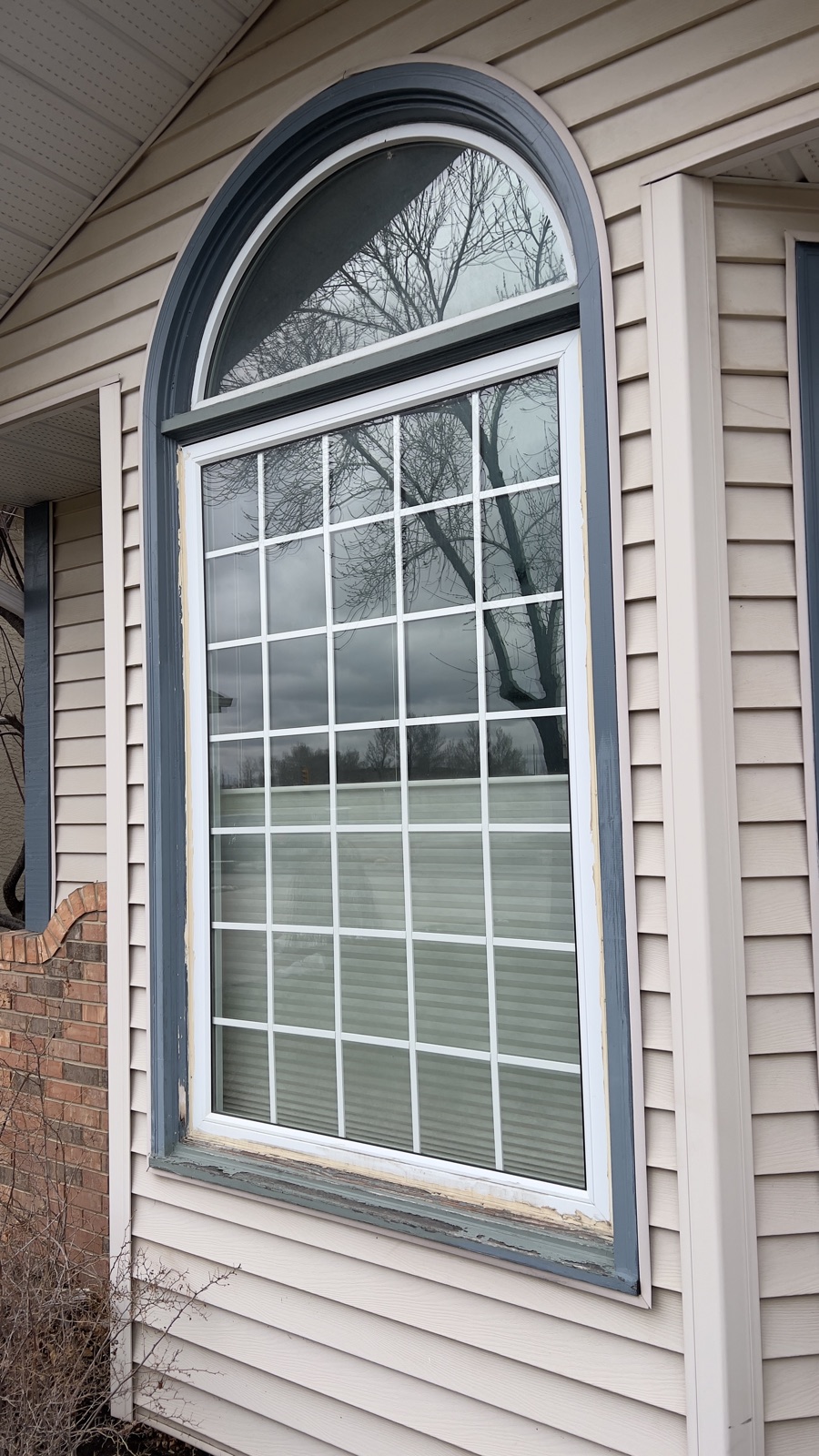 Arch Window — before: worn painted wood trim (Calgary)