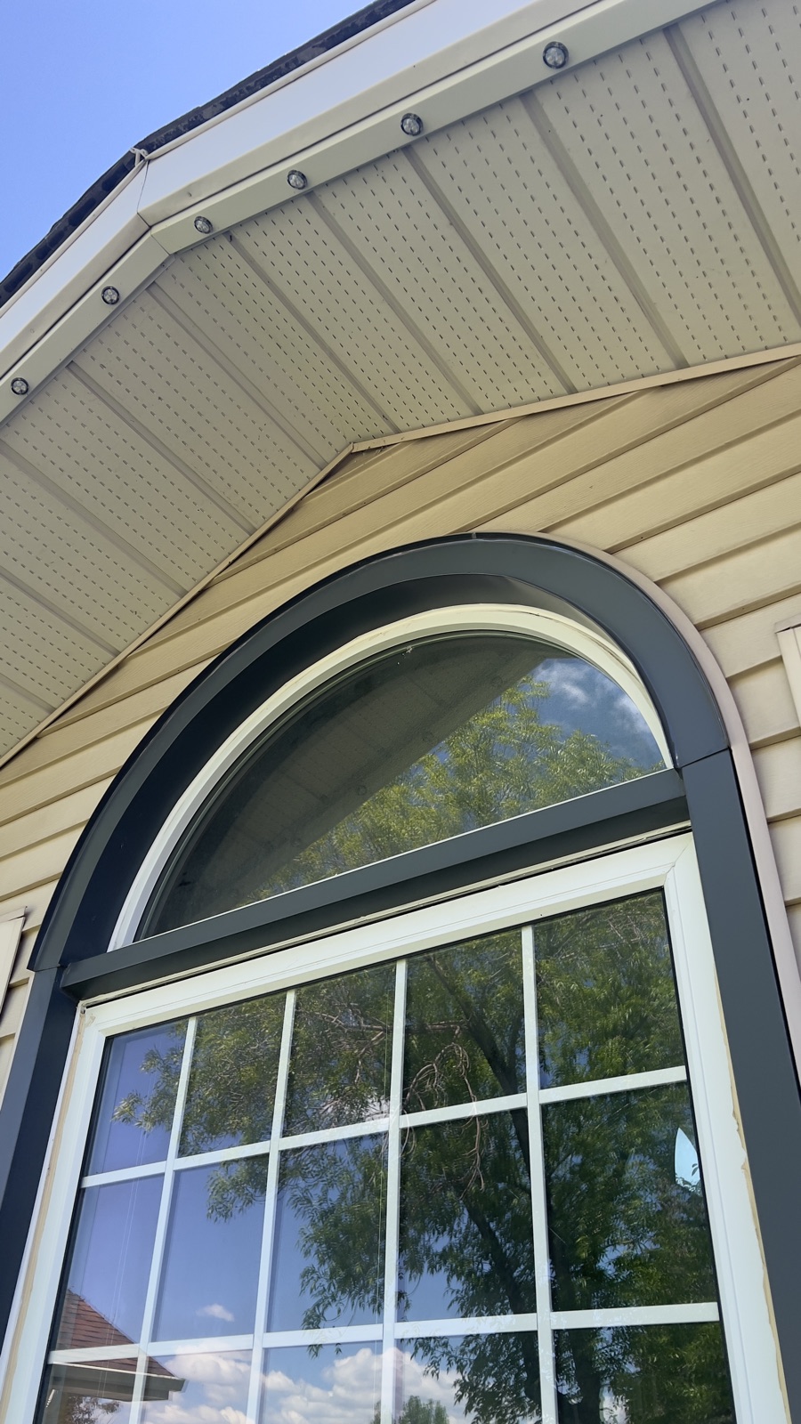 Arched Window — exterior wood trim capped in painted aluminum (Calgary)