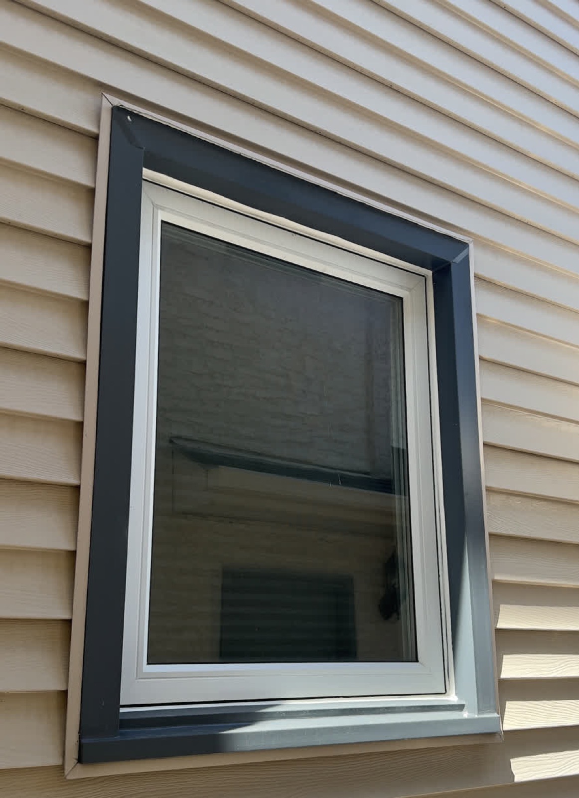 Grey Window — after: capped in custom-bent aluminum, no more repainting (Calgary)