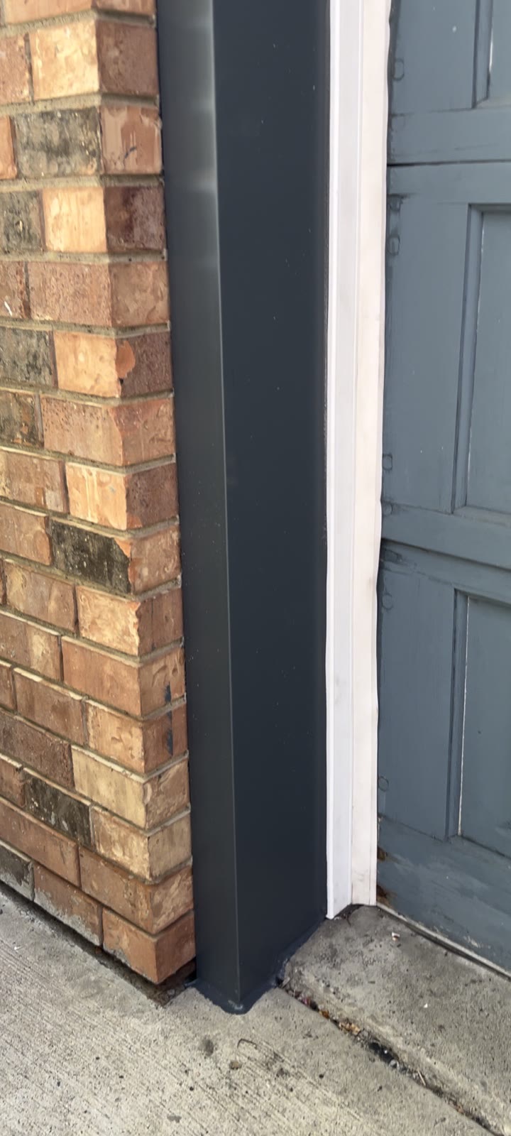 Garage door post before and after — old painted wood capped in custom-bent painted aluminum, no more repainting (Calgary)